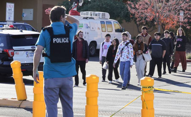LAS VEGAS, NEVADA - DECEMBER 06: People cross Maryland Parkway as they are led off of the UNLV campus after a shooting on December 06, 2023 in Las Vegas, Nevada. According to Las Vegas Metro Police, a suspect is dead and multiple victims are reported after a shooting on the campus. (Photo by Ethan Miller/Getty Images)